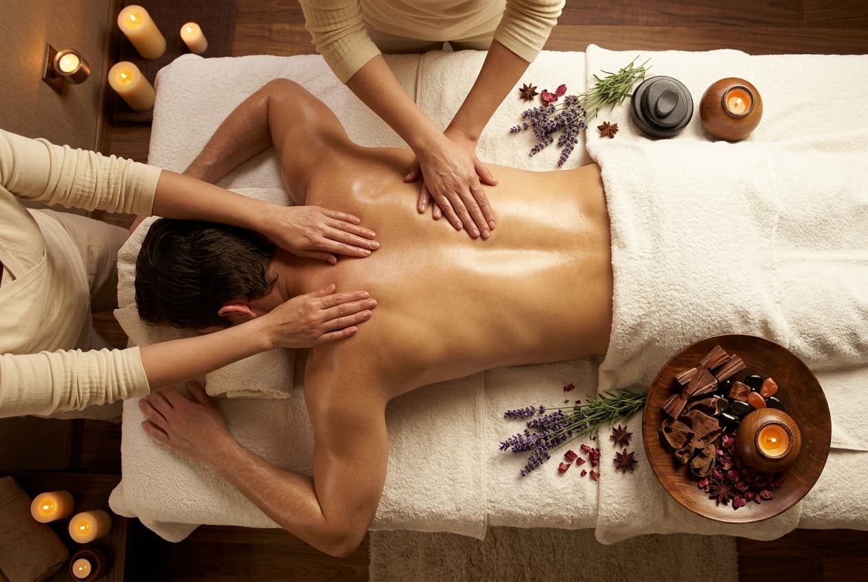 Therapist performing targeted muscle therapy with aromatic spa elements